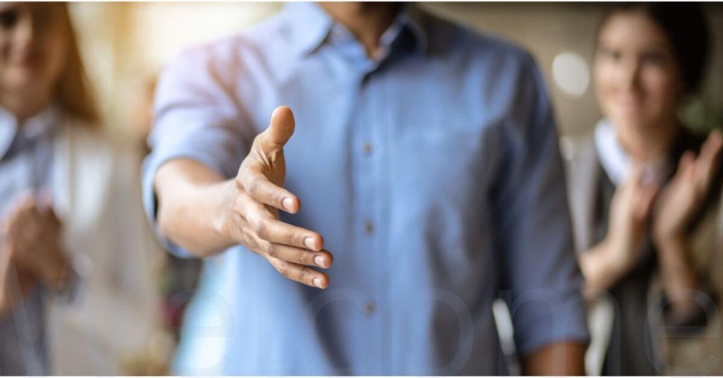 Image of person holding out their hand to shake